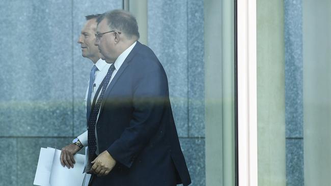 Former Australian prime minister Tony Abbott and Liberal MP Craig Kelly arrive for a party room meeting at Parliament House today. Picture: AAP