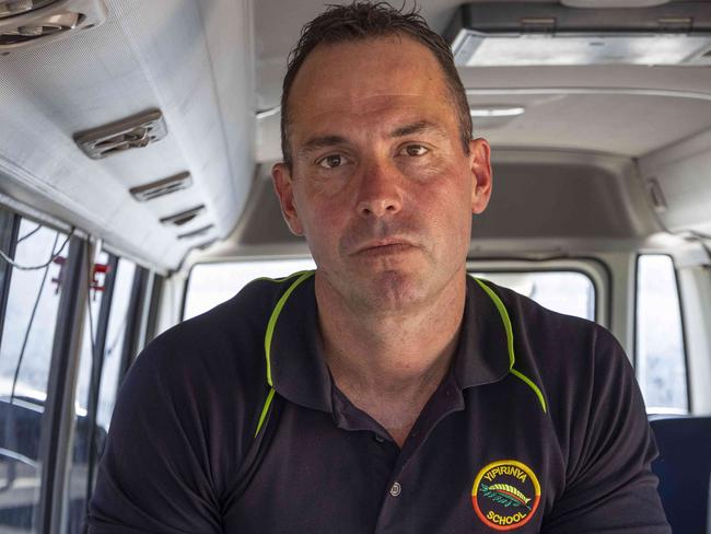 25/04/2023: Alice Springs based Yipirinya School principal Gavin Morris on the school grounds. He is with school minibuses similar to the one that was written off after a mob of students stole it in August 2022 for a joy-ride. PIC: Grenville Turner