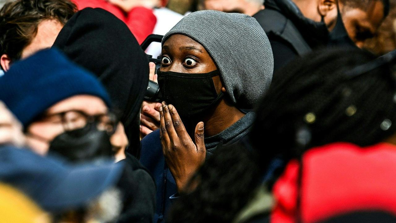 Americans outside the courthouse react to the verdict. Picture: Chandan Khanna/AFP