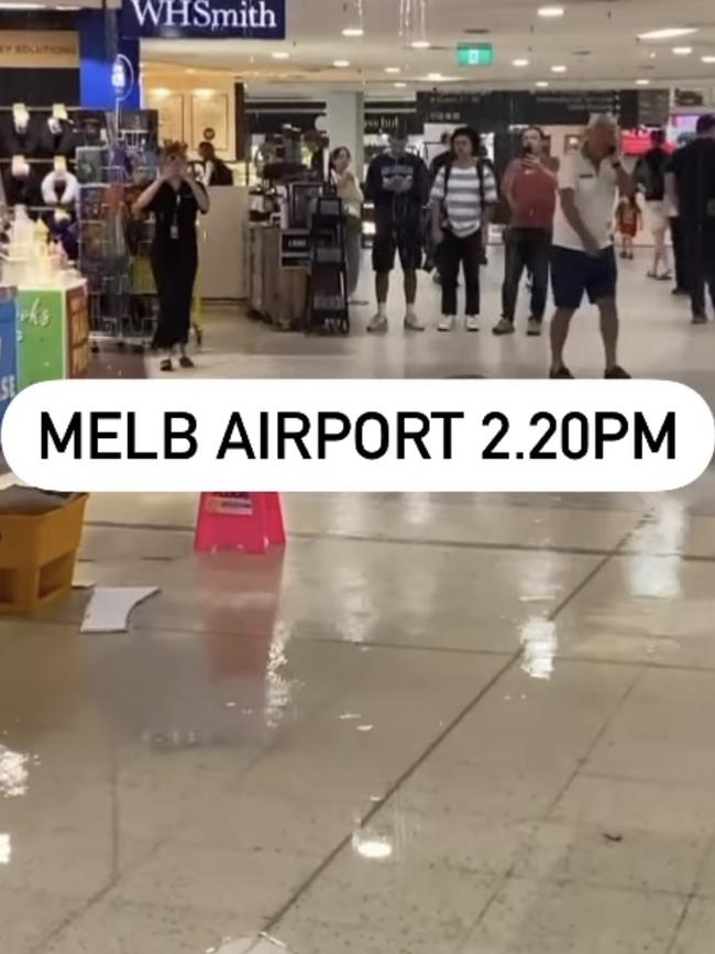 Water pours through the roof of a departure lounge at Melbourne Airport on Thursday. Picture: Jacqui Felgate