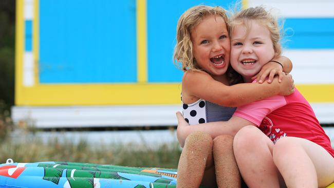 Ivy, 3, and Amber, 5, at Mt Martha beach boxes.