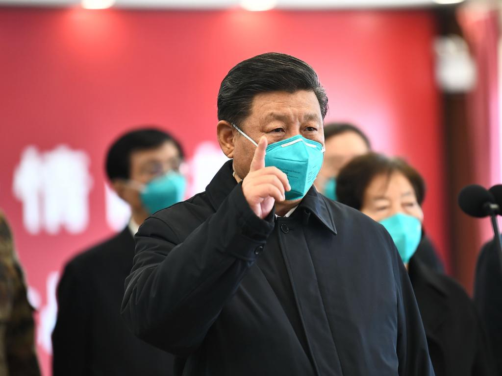 Chinese President Xi Jinping wearing a mask as he gestures to a coronavirus patient and medical staff via a video link at the Huoshenshan hospital in Wuhan. Picture: AFP