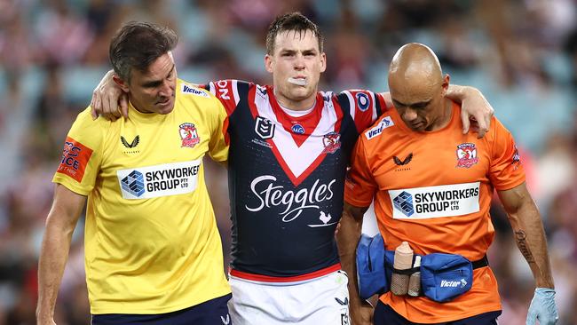 Luke Keary of the Roosters is helped off with a suspected ACL injury (Photo by Cameron Spencer/Getty Images)