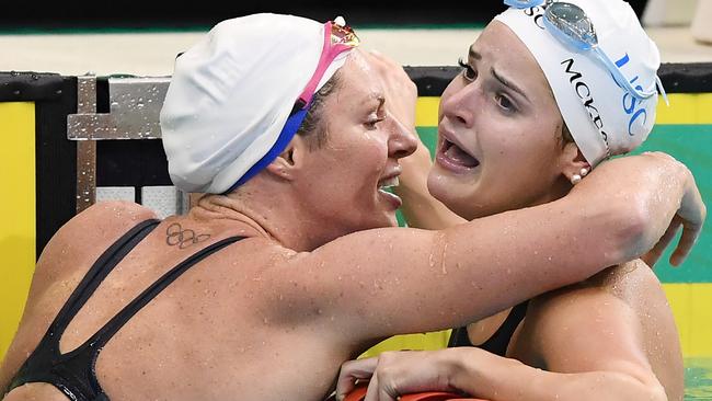 Emily Seebohm hugs Kaylee McKeown after the youngster broke the the world record in the women's 100m backstroke final. Picture: Getty Images