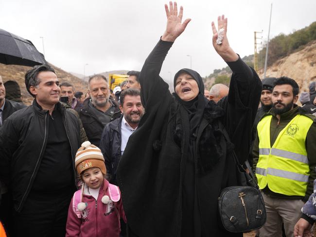 Caretaker Transportation Minister Ali Hamieh, left, welcomes displaced residents returning from Syria at the Masnaa border crossing, eastern Lebanon, following a ceasefire between Israel and Hezbollah. Picture: AP