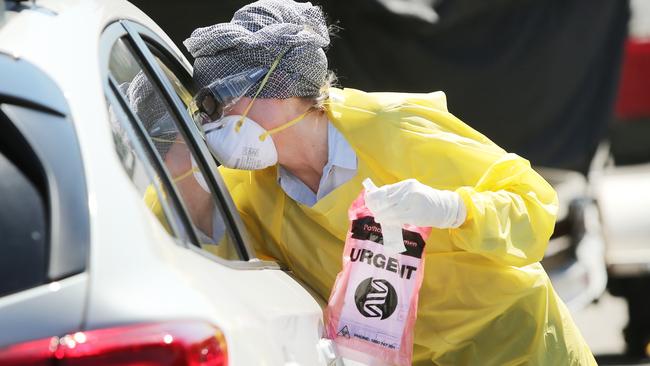 A doctor conducts drive-up COVID-19 tests outside in Maroubra, eastern Sydney. Picture: Richard Dobson