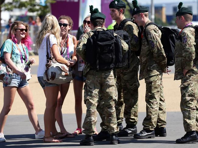 Olympic tourists get advice from soldiers in London, shortly before the 2012 Olympic Games. Their high visibility during the event was perfect PR for the armed forces..