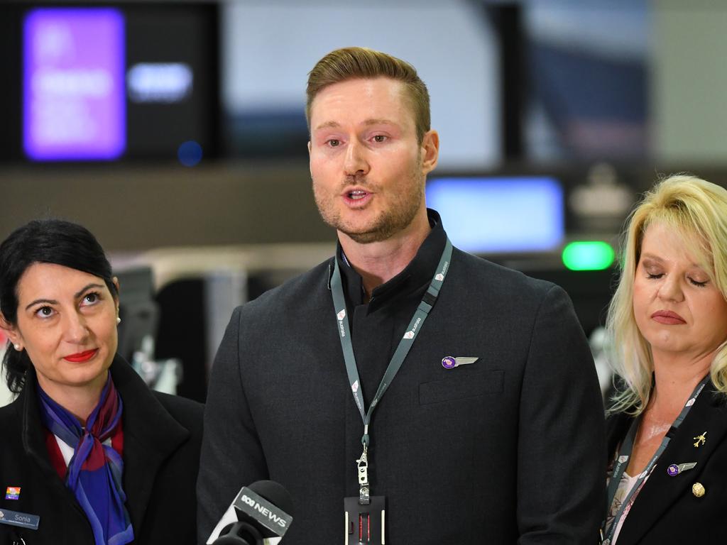 Virgin Australia employee Tony Smith (centre) speaks to the media at Melbourne Airport on Monday. Picture: AAP Image/James Ross
