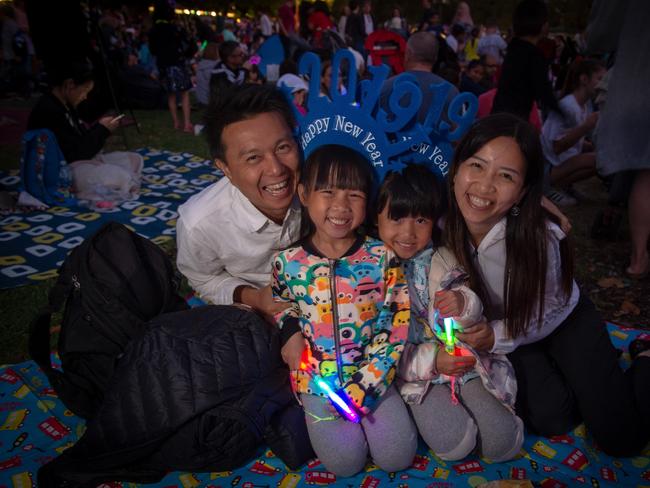 Ken Lai and Sharon Ip with their girls Jolie, 7, and Kaylie, 6, at Yarra Park. Picture: Jay Town