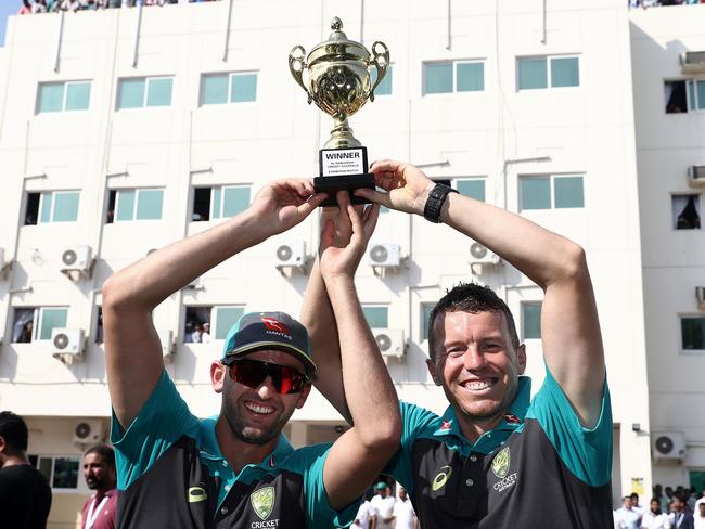 Nathan Lyon and Peter Siddle of Australia visit Al Naboodah Village during the Cricket Cares Visit in Dubai, United Arab Emirates. Picture: Getty Images