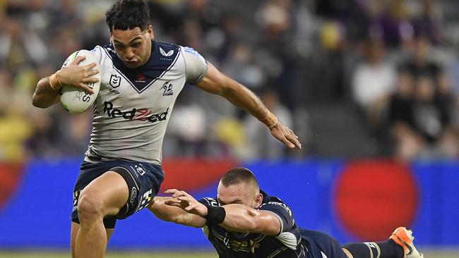 Reimis Smith of the Storm makes a break past Coen Hess of the Cowboys during the round 19 NRL match between the North Queensland Cowboys and the Melbourne Storm at QCB Stadium, on July 23, 2021, in Townsville, Australia. (Photo by Ian Hitchcock/Getty Images)