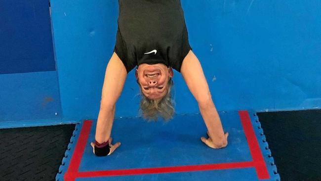 STANDING PROUD: Gold medal winner Helen Brennan does a handstand at CrossFit Kanga. Picture: Cherise Walmsley