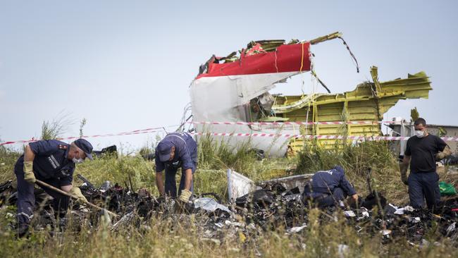 Ukrainian rescue servicemen look through the wreckage of Malaysia Airlines flight MH17 in Grabovo, Ukraine.