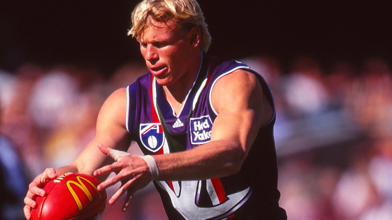 Clive Waterhouse of the Dockers kicks a McDonald's branded Sherrin in 1999. (Photo by Getty Images)