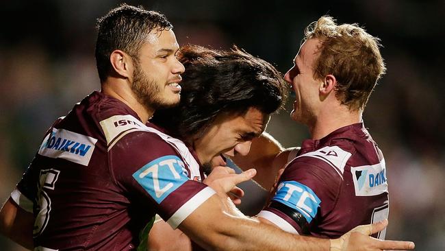 Manly players celebrate after a Jorge Taufua try against the Dragons.