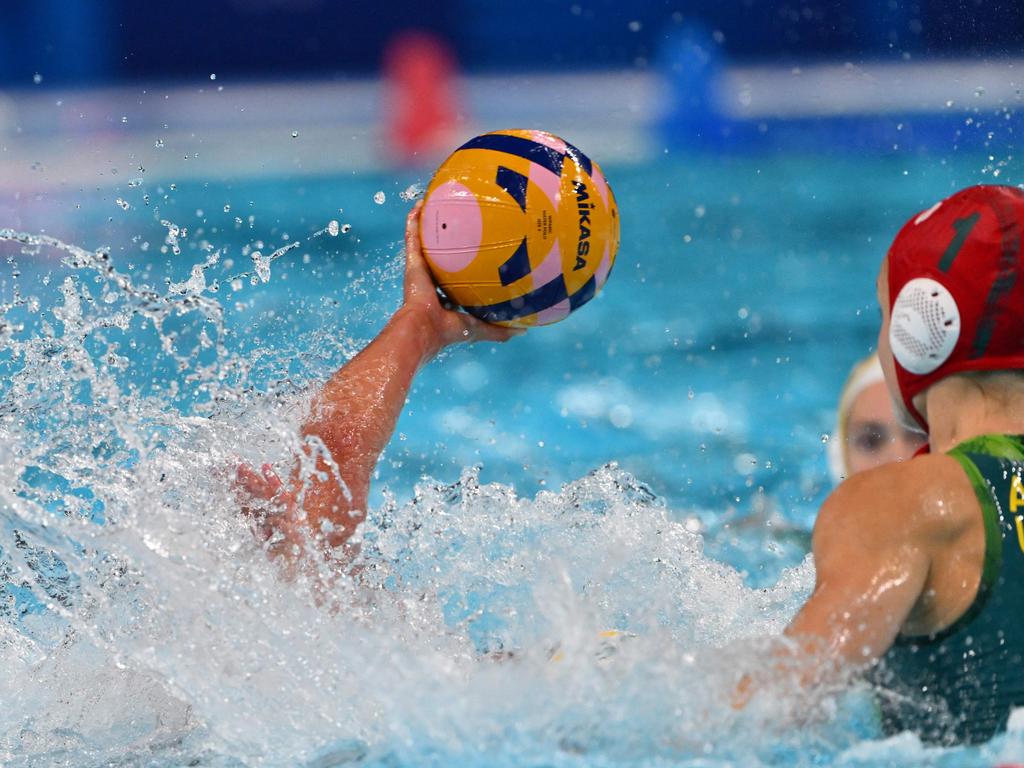 The USA #11 Emily Mary Ausmus (underwater) shoots the ball in the heart-stopper match in which Australia ultimately prevailed to book their berth in the gold medal match. Picture: Andreas Solaro/AFP