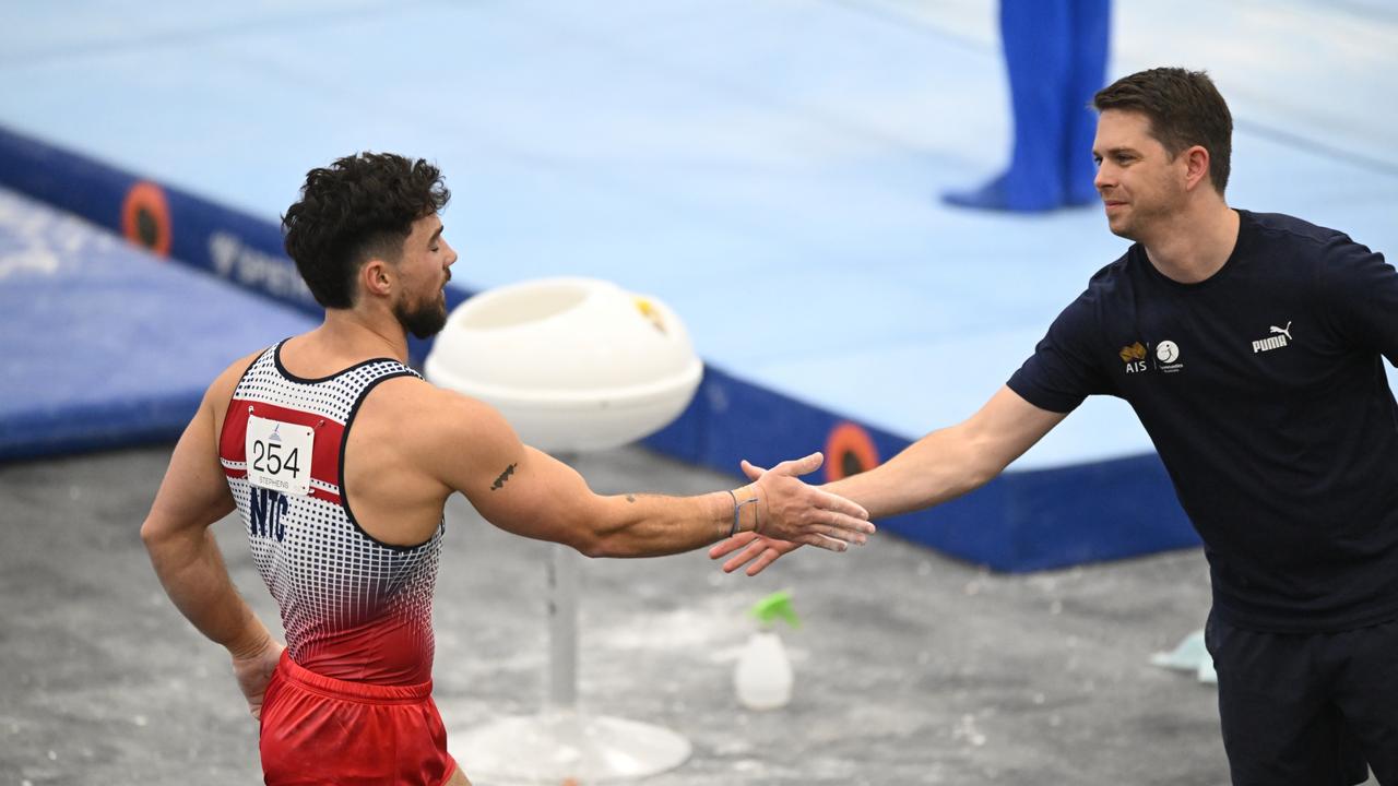 Sean Wilson (right) talks tactics with one of his gymnasts.