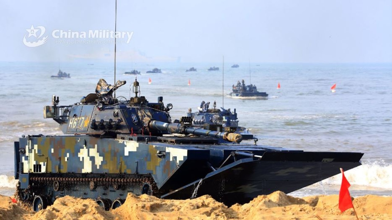 Amphibious armoured vehicles attached to a brigade of the PLA Navy Marine Corps head to shore in formation during a beach raid training exercise. Picture: China Ministry of Defence