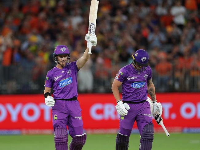 D'Arcy Short of the Hurricanes raises his bat on reaching a century during the BBL cricket match against Perth Scorchers. Picture: AAP IMAGE/RICHARD WAINWRIGHT