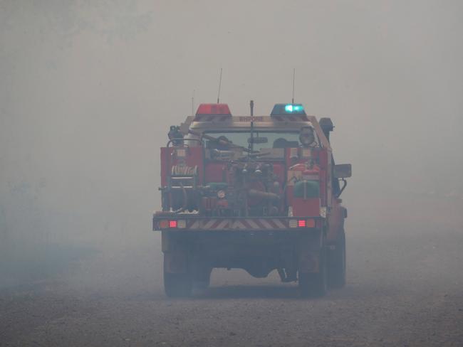 Firefighters battle bushfires in Busbys Flat, northern NSW, Wednesday, October 9, 2019. (AAP Image/Jason O'Brien)