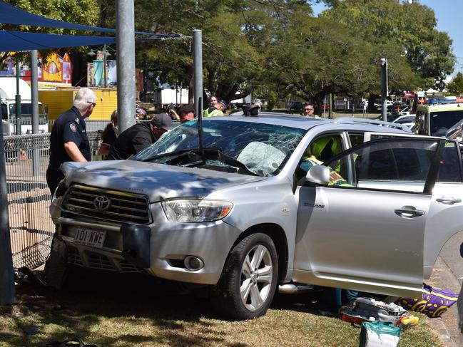 Emergency crews were forced to work to free a woman trapped in the driver’s seat of her SUV vehicle after an apparent collision with a truck sent her vehicle careening off the Bruce Highway and into a children’s playground in the centre of Ingham. Picture: CAMERON BATES