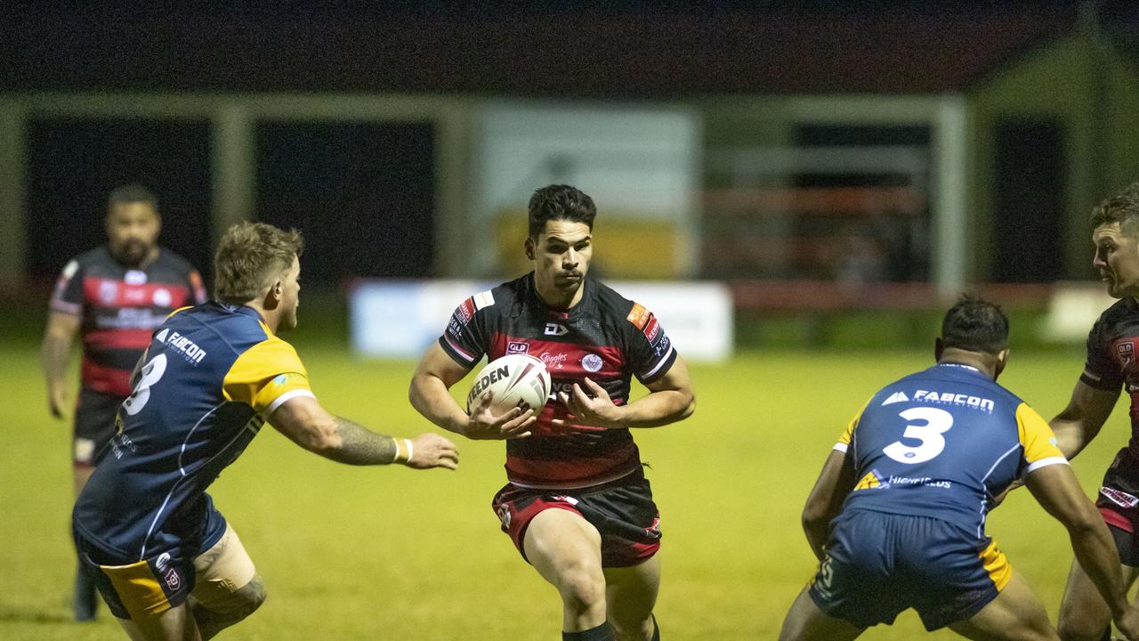 Brock Diment (centre) break through a gap. Picture: Nev Madsen