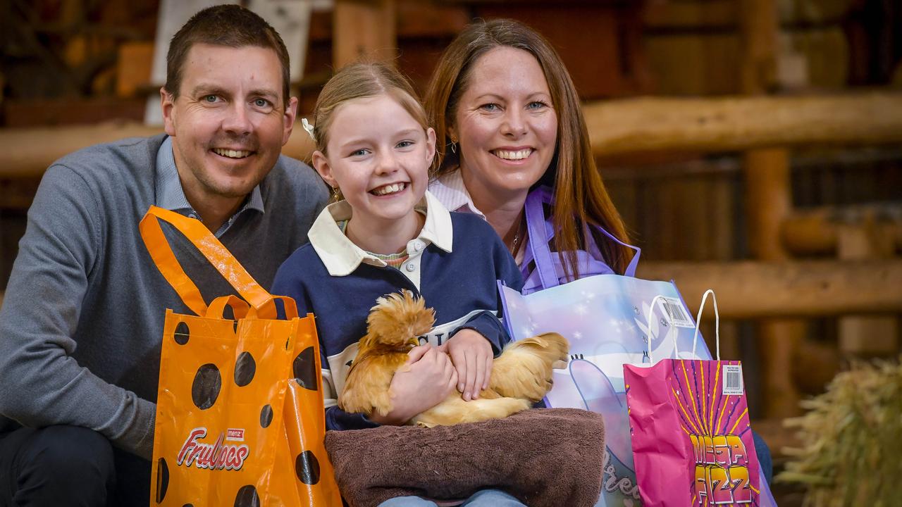 Ella McKay, 9, with Pom Po the chicken and mum and dad, Kristy and Mark. Picture: RoyVphotography