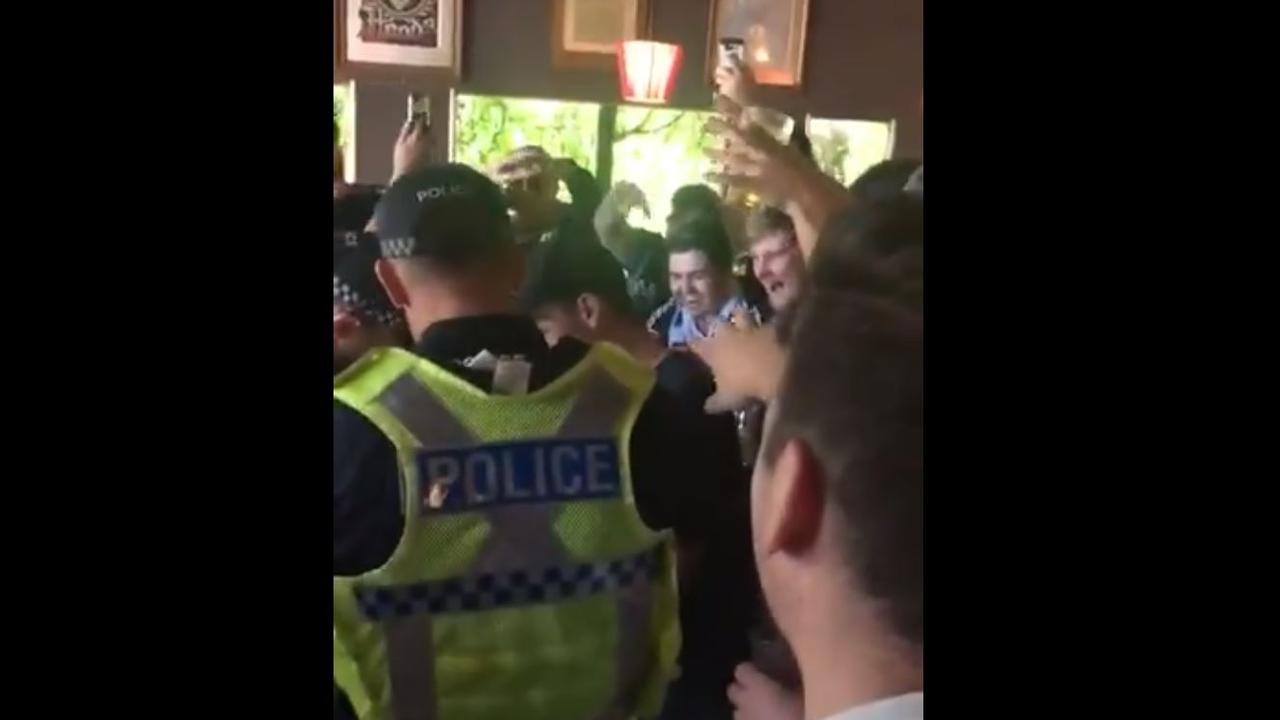 Melbourne Victory fans celebrate after a failed flare search by police.
