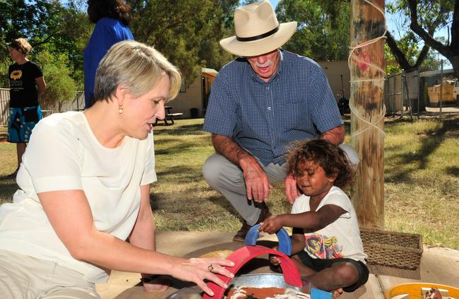 Labor education spokesman and deputy leader Tanya Plibersek and Labor’s member for Lingiari play with a small child in Central Australia. Picture: Satria Dyer-Darmawan 