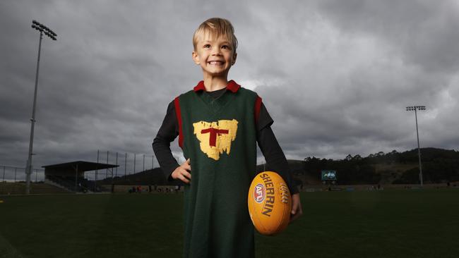 Jenson Peterson 5 wearing his grandfathers (Robert Dykes) Tasmanian state playing jumper. Picture: Nikki Davis-Jones