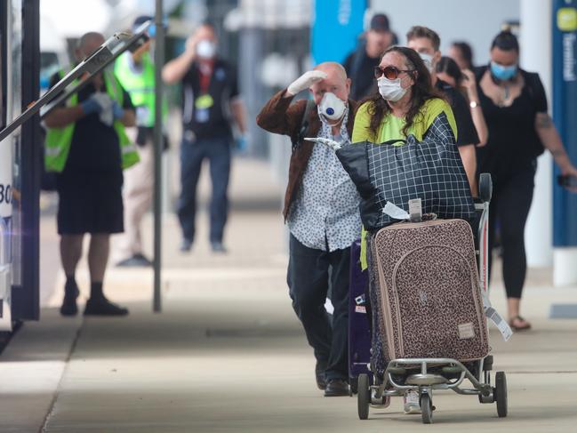 Travellers arrive at Darwin International Airport as all Interstate arrivals require 14 days in Quarantine.Picture GLENN CAMPBELL