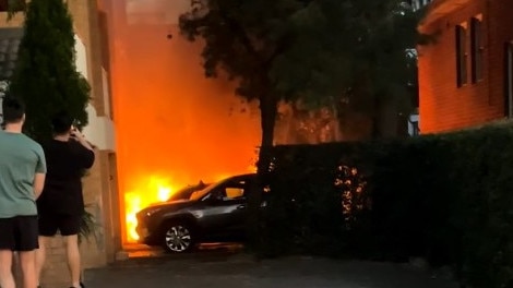 A Porsche believed to have been used by the block ponchoi-clad assassins as a getaway car was torched in nearby Kensington. Picture: Supplied