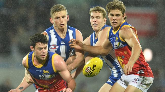 HOBART, AUSTRALIA - JUNE 19: Jack Ziebell of the Kangaroos and Lachie Neale of the Lions compete for the ball during the round 14 AFL match between the North Melbourne Kangaroos and the Brisbane Lions at Blundstone Arena on June 19, 2021 in Hobart, Australia. (Photo by Steve Bell/Getty Images)