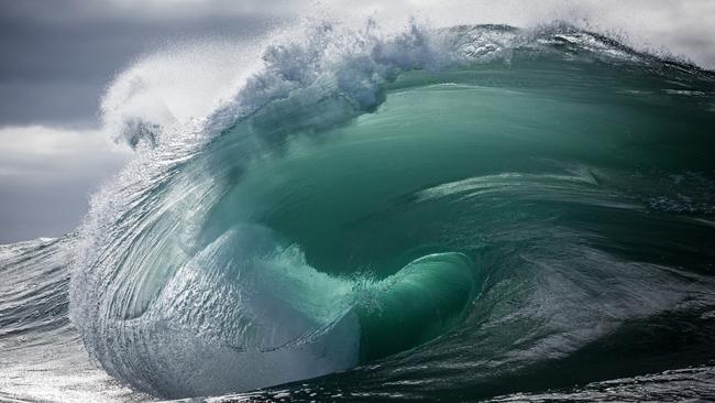 Keelan swims out into the swell, sometimes with a body board to perch on, but often with just his swim fins, camera and its waterproof housing to capture the perfect shot. Picture: Warren Keelan