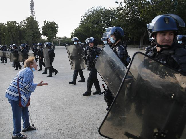 An elderly woman heckles police during a demonstration in Paris. Picture: AP