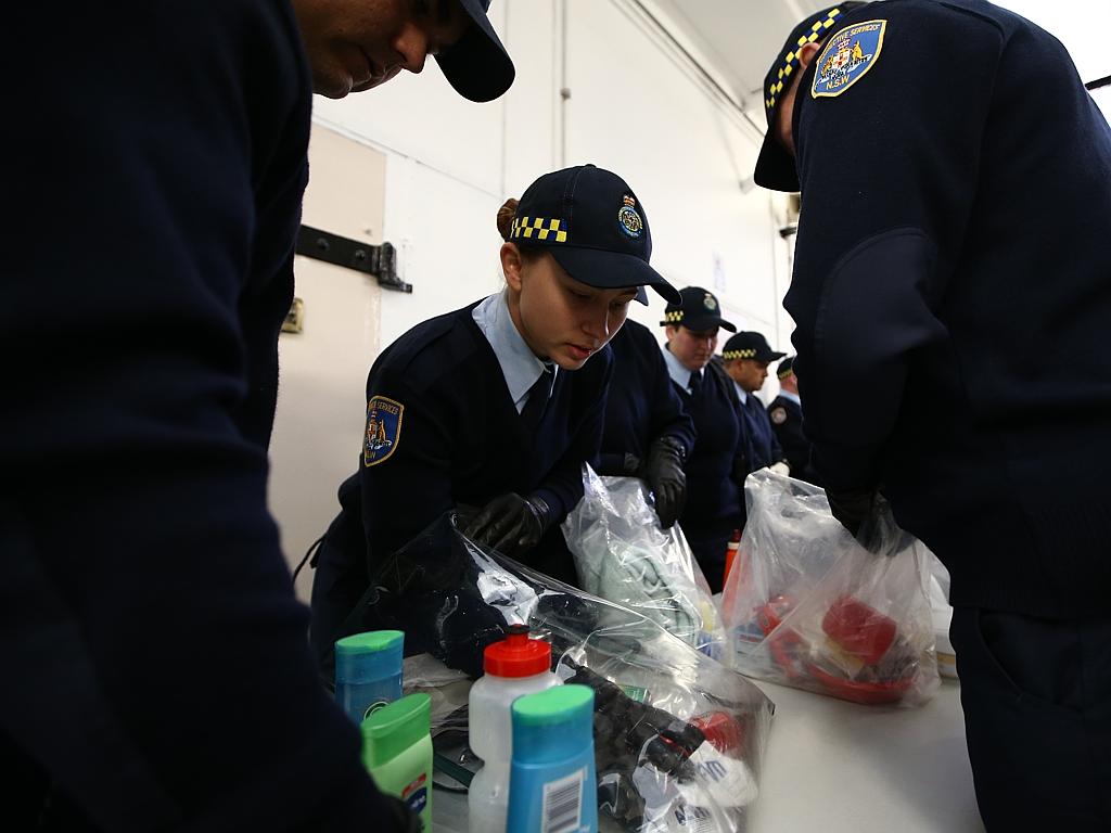 Correctional officer trainee Rhiannan Harvey searches through the belongings of inmates at Long Bay. Picture: Tim Hunter