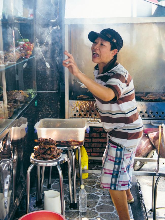 A Saigon chef cooks char grilled pork cutlets. Picture: Alan Benson