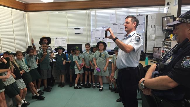 Sgt Gregory showing St Mary's School students around Bowen Police Station in 2016.