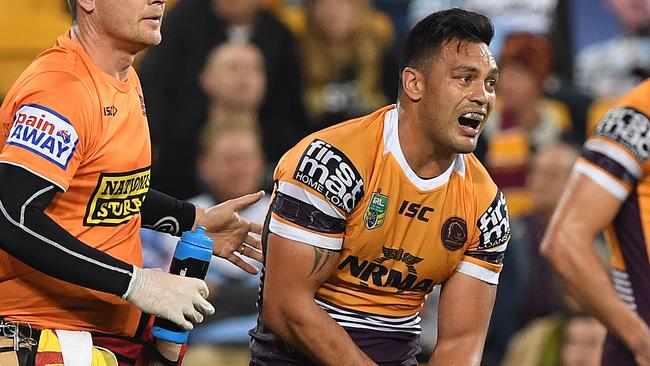 Alex Glenn of the Broncos holds his wrist as he is attended to by medical staff during the Round 20 NRL match between the Brisbane Broncos and the Cronulla-Sutherland Sharks at Suncorp Stadium in Brisbane, Thursday, July 26, 2018. (AAP Image/Dave Hunt) NO ARCHIVING, EDITORIAL USE ONLY