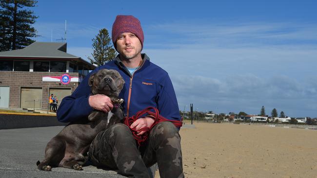 Justin Imhoff with his dog, Buddy, who was attacked by an off-leash dog at Elwood beach. Picture: Josie Hayden