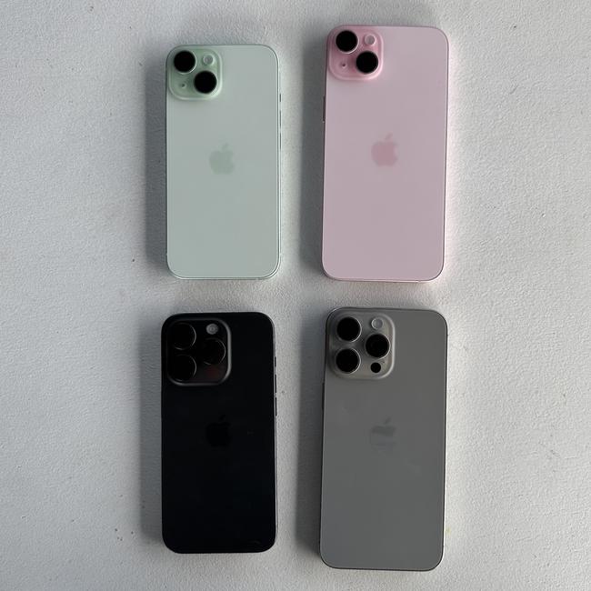 From clockwise: The green iPhone 15, the pink iPhone 15, titanium iPhone 15 Pro Max and black iPhone 15 Pro. Picture: Supplied.