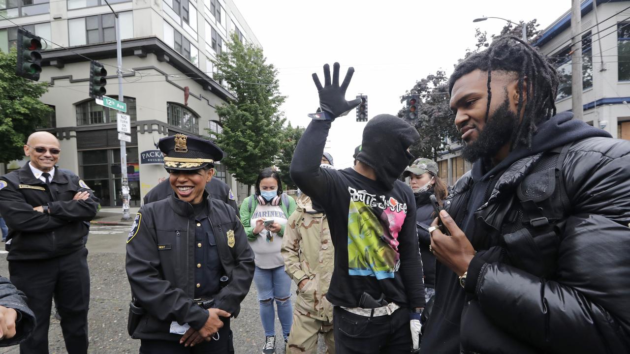 Seattle Police Chief Carmen Best, second left, met with Mr Simone before the takeover last week. Picture: Elaine Thompson/AP