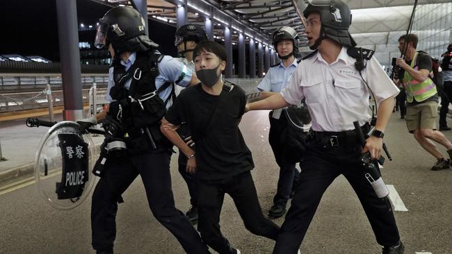 Police arrest a protester during a clash at the Airport in Hong Kong. Picture: AP