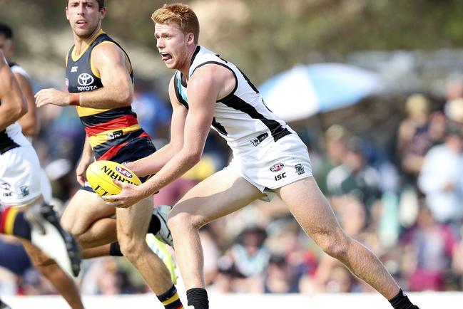 Port Adelaide’s Willem Drew looks to handball in the JLT Series amtch against the Crows at Port Pirie. Picture SARAH REED