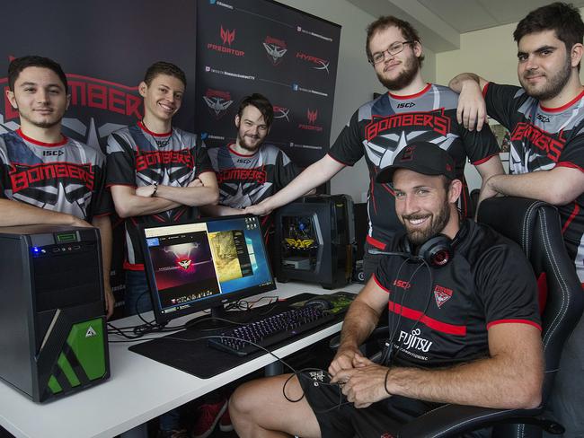 Essendon footballer Cale Hooker in the driver’s seat with Carlo La Civita, Alan Roger, Andrew Rose, Christian Tiensuu and Captain Sebastian De Ceglie. Picture: Ian Currie