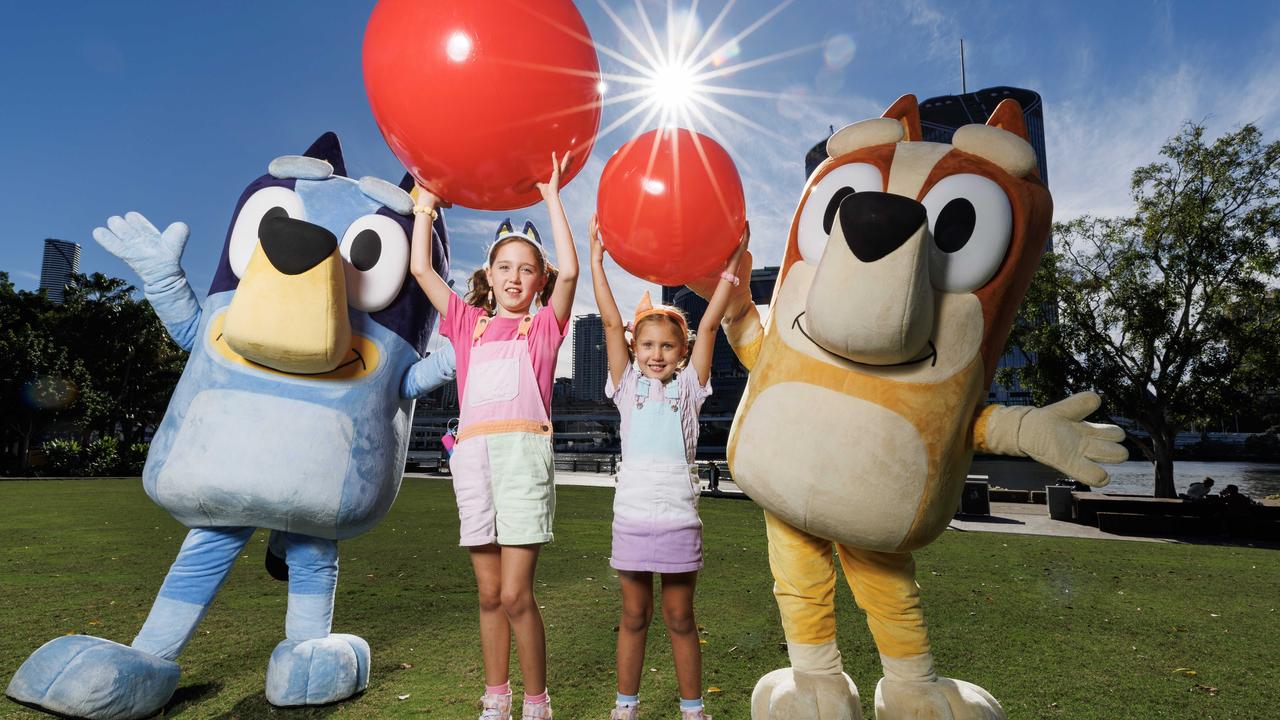 Sisters Jasmine 7, and Lilah Johnstone 5, with Bluey and Bingo after taking part in the Bluey world record attempt for the biggest game of Keep Uppy. Picture Lachie Millard