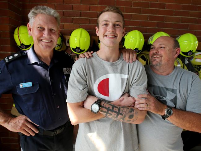 Samuel Lethbridge with his father Tony and firefighter Allen Jenkins, who along with his crew, rescued him from his car after an accident. Picture: Nathan Edwards