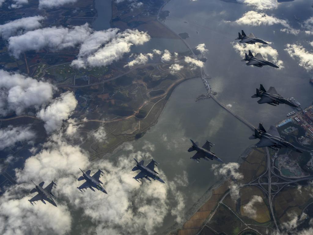 South Korean Air Force F-15Ks and US Air Force F-16 fighters flying over South Korea in response to North Korea a missile over Japan. Picture: Getty Images