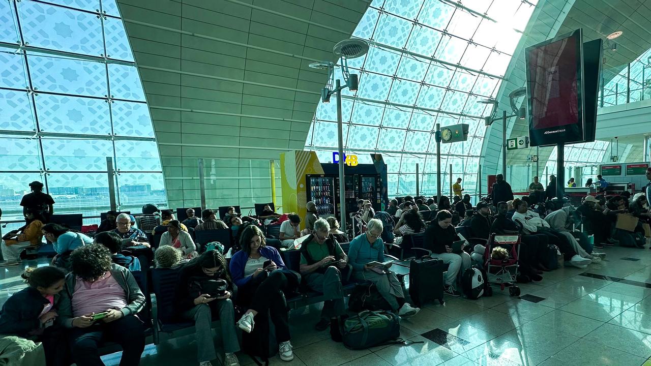 Passengers wait for their flights at the Dubai International Airport after the rains caused chaos. (Photo by AFP)