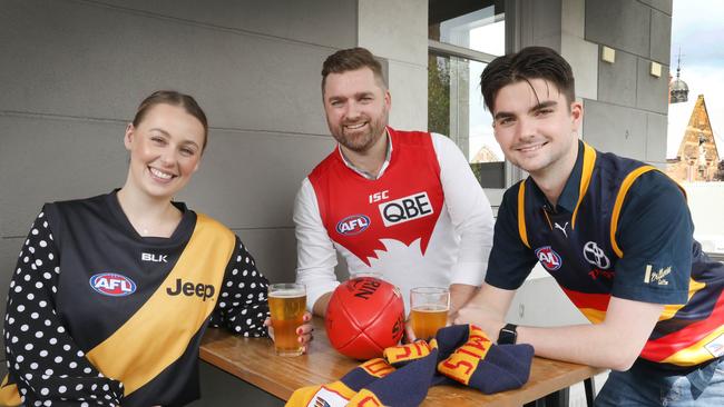 Holly Payne (Richmond), Kym Bond, (Sydney) and Jack Trim, (Crows) looking forward to providing some of the hospitality to interstate visitors for the AFL Gather Round. Picture: Dean Martin